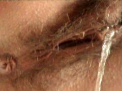 Babe with a hairy puss is pissing so sexy