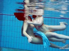 Girls in elegant dresses swimming underwater